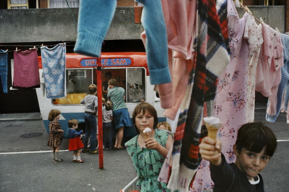 Kids with ice cream cones at the Uncle Sam van, clothesline overhead